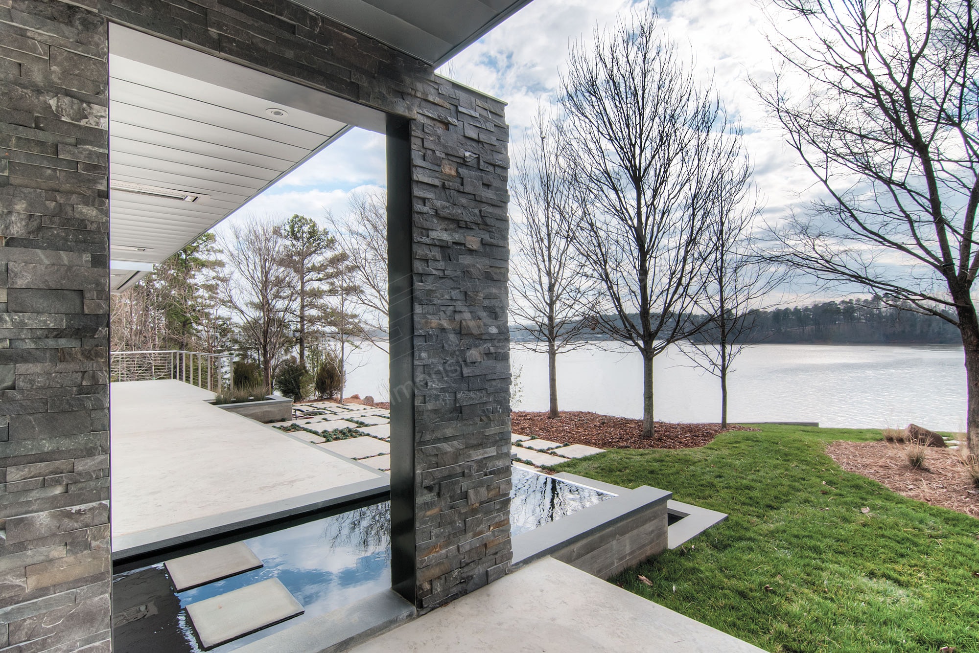 Dry stack stone veneer used exterior on a North Carolina Lake in a freeze thaw climate